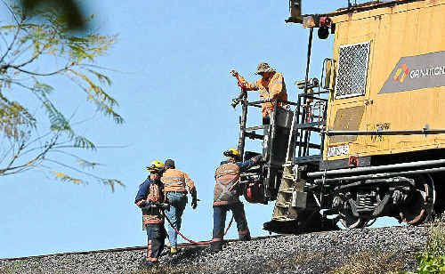 Rail workers put out grass fires caused by rail grinding work near the Grafton Bridge. Rail workers put out grass fires caused by rail grinding work near the Grafton Bridge.