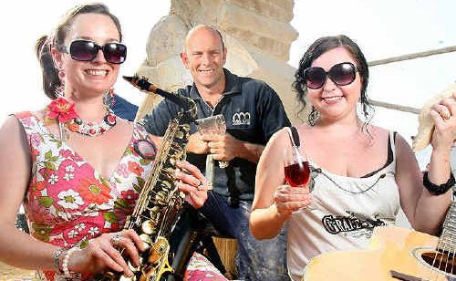Katie Toohey, sculptor Daniel Gill and Natasha Campbell get into the swing of the Soulful Spring Sounds, being held at Warrego Wines on Saturday. 