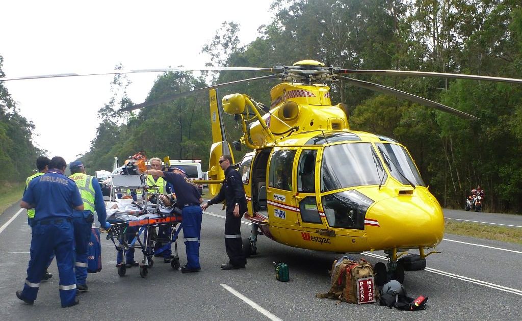 Rescuers at the scene of Saturday’s accident on the Pacific Highway at Harwood, north of Maclean. Rescuers at the scene of Saturday’s accident on the Pacific Highway at Harwood, north of Maclean.