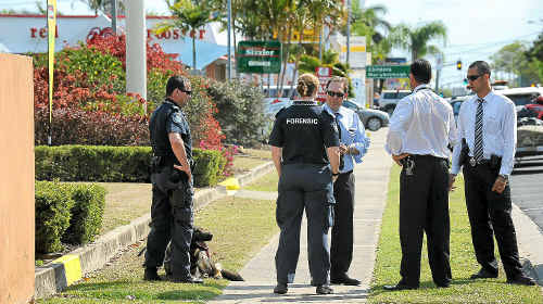 Police discuss their next move outside the Sugar Country Motor Inn’s Rendezvous restaurant, in Bourbong St. Police discuss their next move outside the Sugar Country Motor Inn’s Rendezvous restaurant, in Bourbong St.