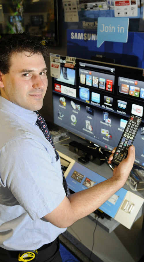SMART TELLY: Harvey Norman salesman Andrew Erlandson shows the basic differences between one Smart TV and the next. SMART TELLY: Harvey Norman salesman Andrew Erlandson shows the basic differences between one Smart TV and the next.