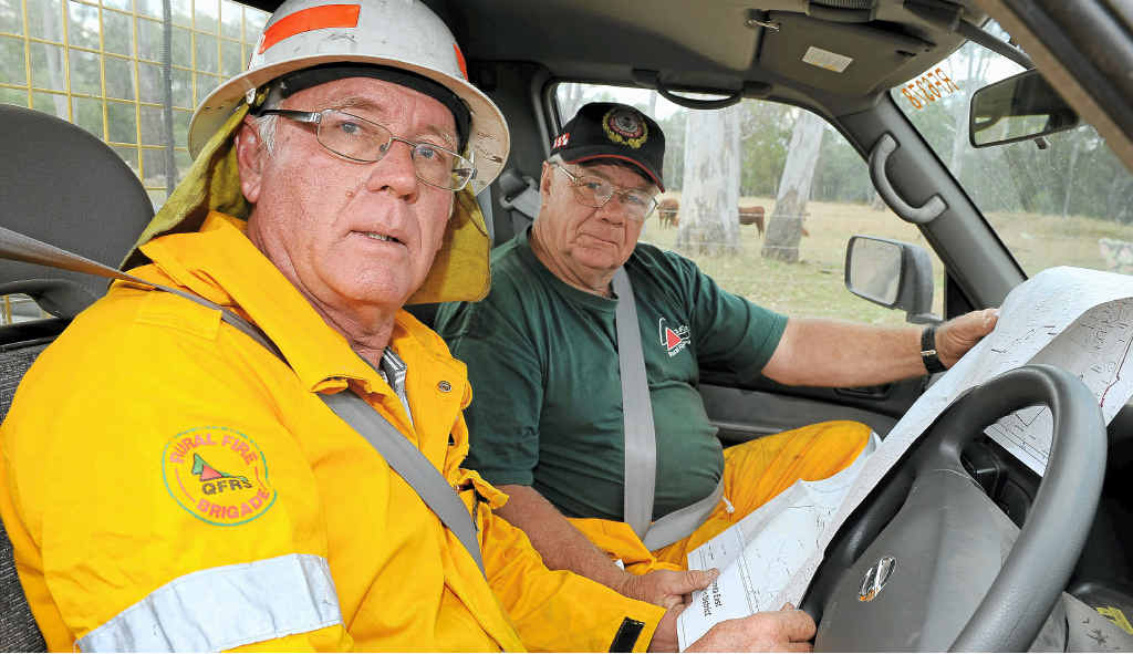 Phillip Kelly and Bob Muir look at a map of the region before heading off to a Tablelands Rd fire. Phillip Kelly and Bob Muir look at a map of the region before heading off to a Tablelands Rd fire.