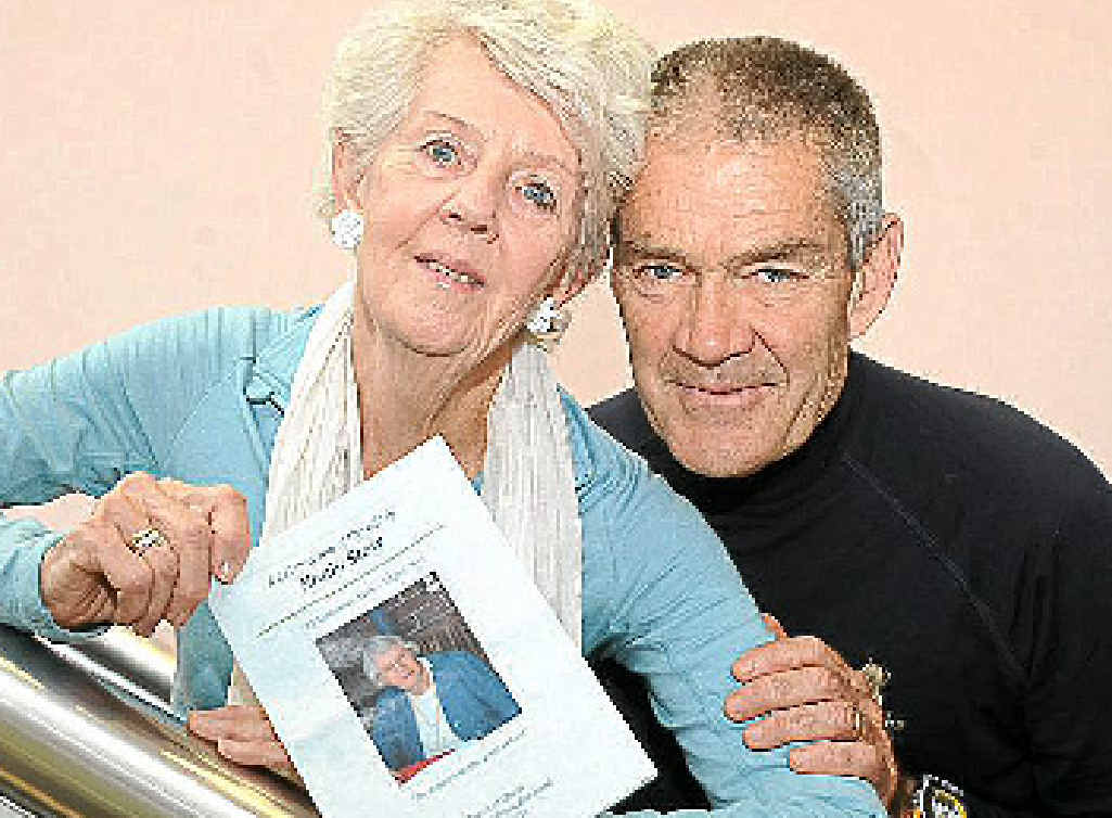 Isabel (Rae) and husband Geoff Kennedy with the program for the funeral of her Aunty Noala Stow (Wotherspoon). 
