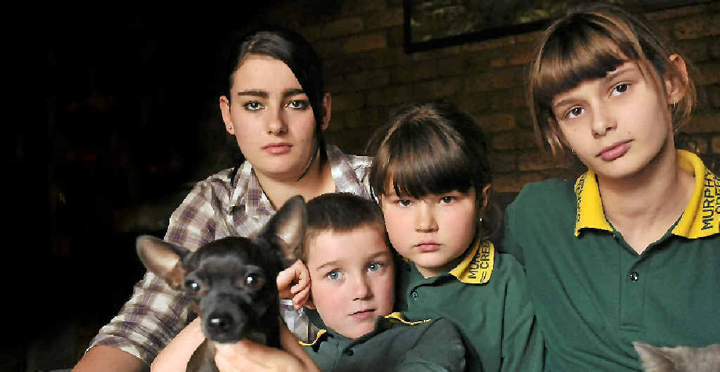 Mourning the loss of their pet dog, which was decapitated on Monday, are siblings (from left) Tiana Gorry, 17, Corrie Blizzard, 6, Nikita Cook, 8, and Shyenne Blizzard, 12. Mourning the loss of their pet dog, which was decapitated on Monday, are siblings (from left) Tiana Gorry, 17, Corrie Blizzard, 6, Nikita Cook, 8, and Shyenne Blizzard, 12.