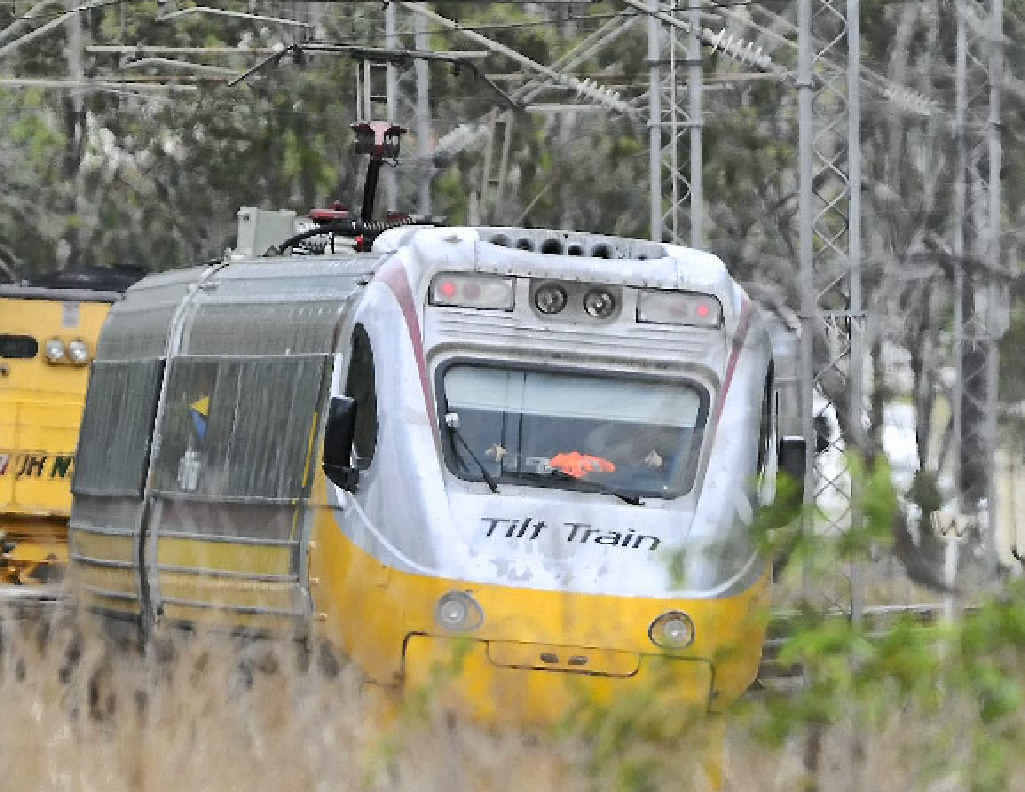A passenger tilt train passing through Mt Larcom is stopped on tracks due to damage on overhead power lines. A passenger tilt train passing through Mt Larcom is stopped on tracks due to damage on overhead power lines.