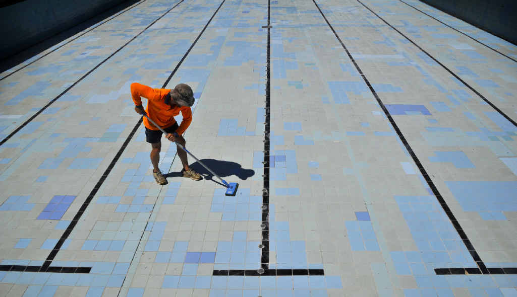 Rick Sampson does some work on the tile base of the Grafton Aquatic Centre main pool. Rick Sampson does some work on the tile base of the Grafton Aquatic Centre main pool.