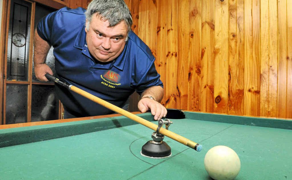 Coral Coast Men’s Shed president Michael Garrett invented this pool cue-holding device. Coral Coast Men’s Shed president Michael Garrett invented this pool cue-holding device.