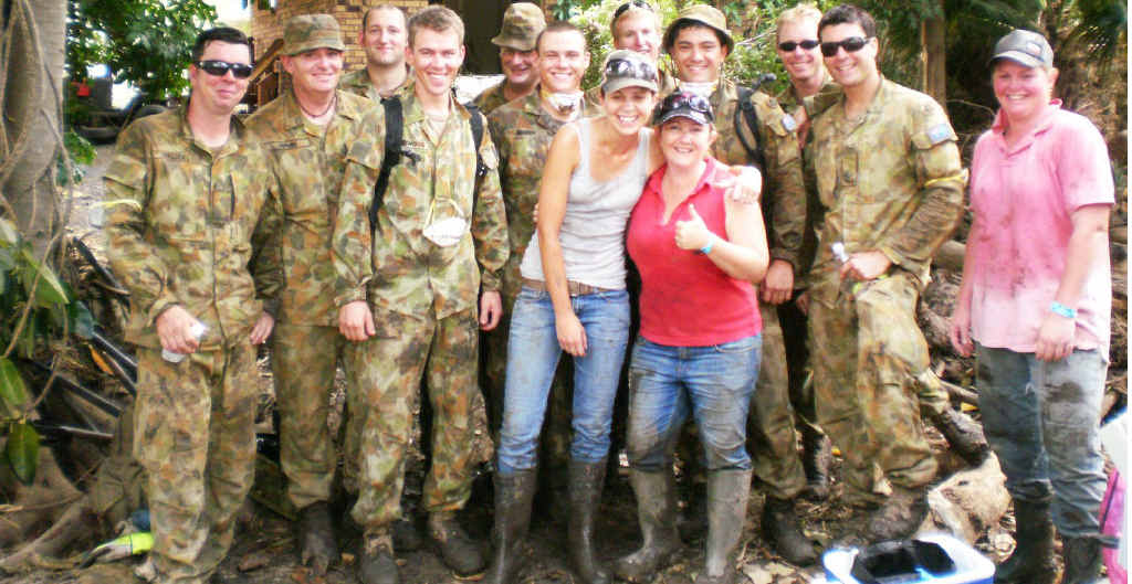 Amanda Kerle (centre) takes a quick break from cleaning her mother-in-law’s flood-devastated Grantham home with her friends Zoie Khan (left), Kristy Taylor and army personnel in January. Amanda Kerle (centre) takes a quick break from cleaning her mother-in-law’s flood-devastated Grantham home with her friends Zoie Khan (left), Kristy Taylor and army personnel in January.