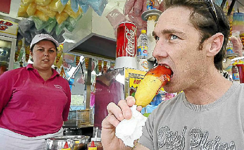 Wilson Turner of South Lismore tucking into a Dagwood dog as Belinda Stewart of McDonalds catering looks on. Wilson Turner of South Lismore tucking into a Dagwood dog as Belinda Stewart of McDonalds catering looks on.