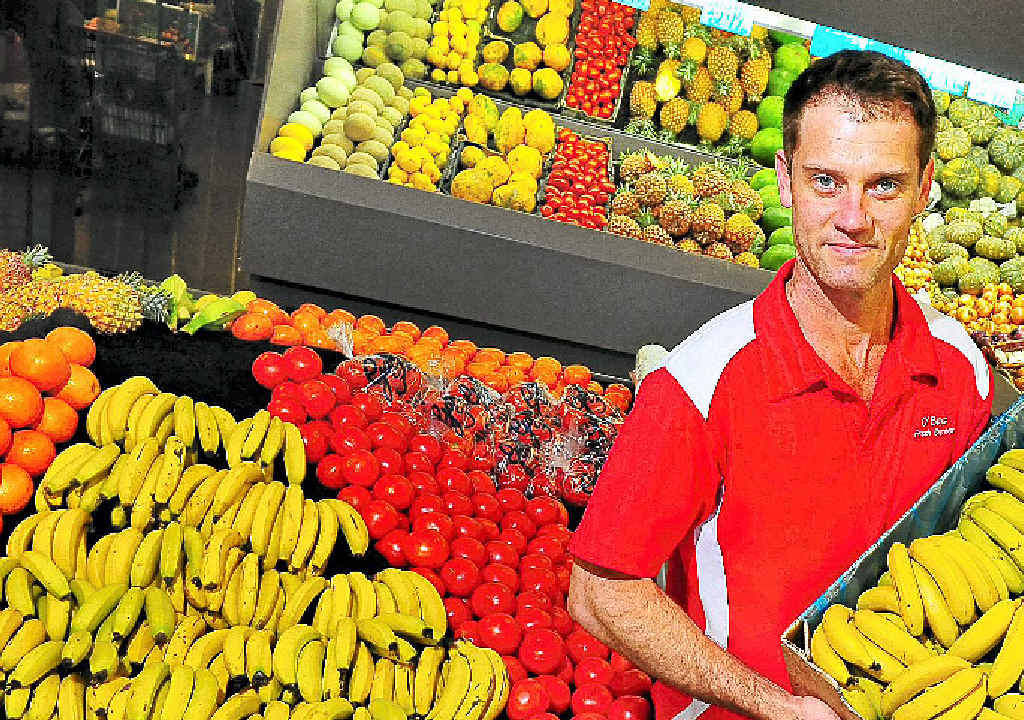 Oboy’s Fresh Express owner Darryl Schulte with a box of local bananas that are now down to $5.99kg. Oboy’s Fresh Express owner Darryl Schulte with a box of local bananas that are now down to $5.99kg.