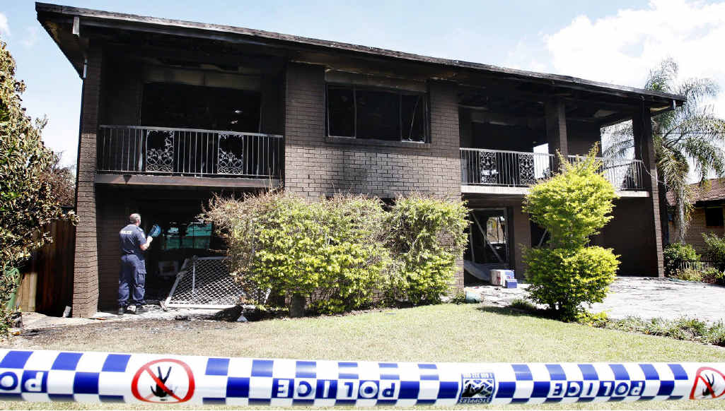 Police and fire investigators inspect the Bundamba house that went up in flames yesterday. Police and fire investigators inspect the Bundamba house that went up in flames yesterday.