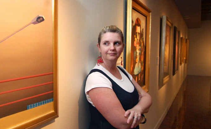 Rockhampton Art Gallery manager Tracy Lavery with a painting by Jeffrey Smart which is on display as part of the Highlights from Rockhampton Art Gallery Collection exhibition.
