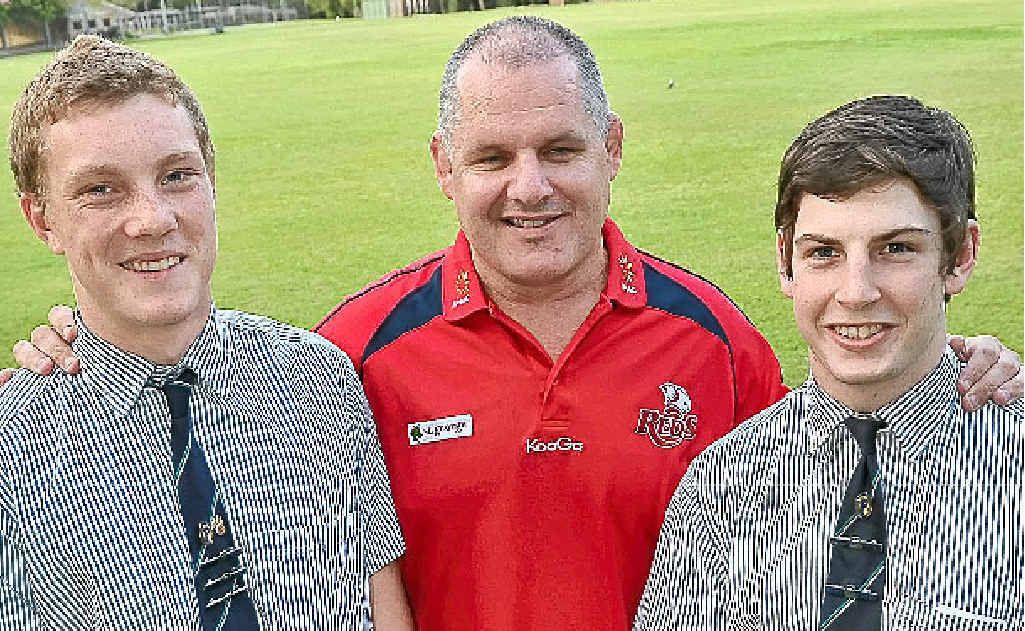 Ewen McKenzie rubs shoulders with Matthew Flinders Anglican College’s rugby captains, Kyle Palmer, left, and Seb Campbell. Ewen McKenzie rubs shoulders with Matthew Flinders Anglican College’s rugby captains, Kyle Palmer, left, and Seb Campbell.