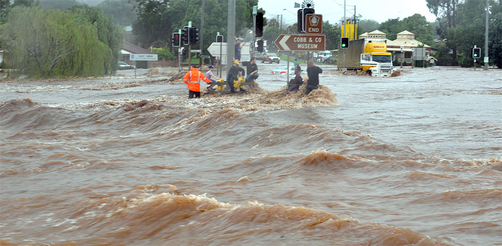 Blake Rice (blue baseball cap) with his rescuers at the James and Kitchener sts intersection moments after his mother and brother were washed away in floodwater. Blake Rice (blue baseball cap) with his rescuers at the James and Kitchener sts intersection moments after his mother and brother were washed away in floodwater.