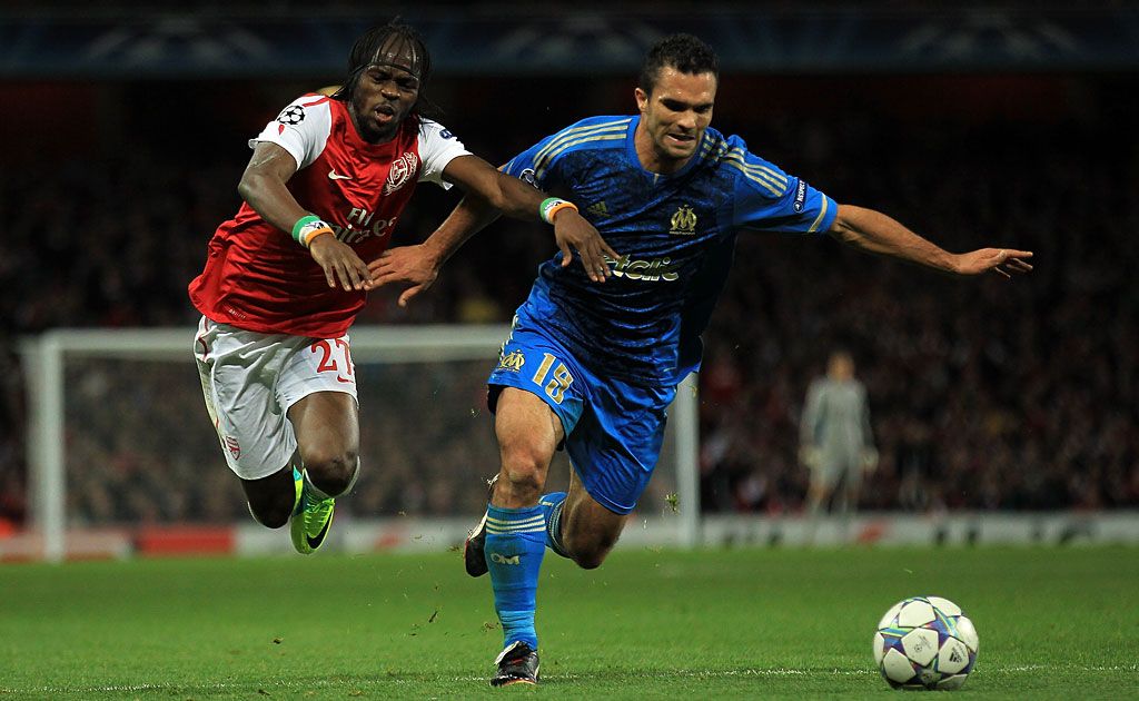 Gervinho of Arsenal battles for the ball with Morgan Amalfitano of Olympique de Marseille during the UEFA Champions League Group F match between Arsenal FC v Olympique de Marseille at Emirates Stadium in London, England. Gervinho of Arsenal battles for the ball with Morgan Amalfitano of Olympique de Marseille during the UEFA Champions League Group F match between Arsenal FC v Olympique de Marseille at Emirates Stadium in London, England.