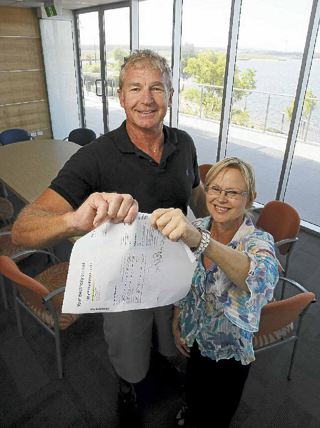 GOODBYE COST: RGD’s Ron Grabbe and Tracey Carbis rip up an electricity bill. GOODBYE COST: RGD’s Ron Grabbe and Tracey Carbis rip up an electricity bill.