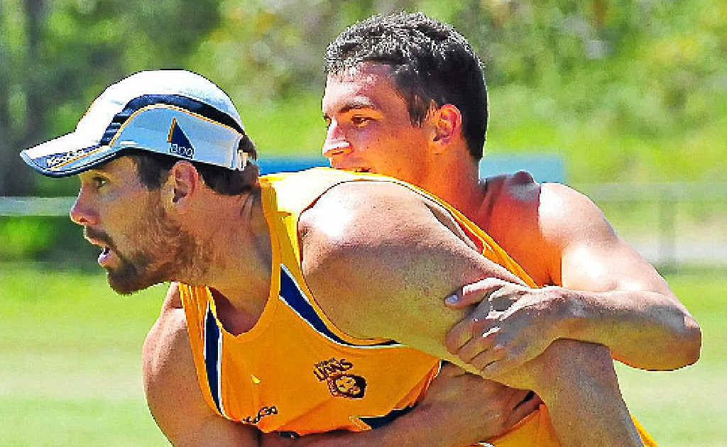 Brisbane Lions player Tom Rockliff wraps up Brisbane Lions recruit Ben Hudson as they train at Noosa. Brisbane Lions player Tom Rockliff wraps up Brisbane Lions recruit Ben Hudson as they train at Noosa.
