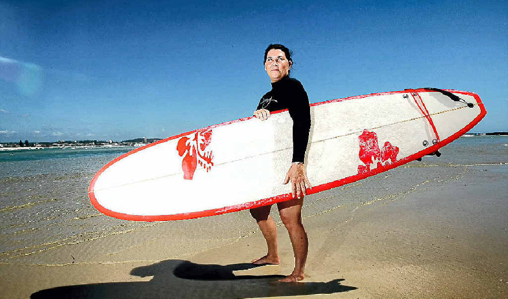 ICONIC BEACH LIFESTYLE: Janine Rawlings at home with her surfboard on Currumbin Beach. ICONIC BEACH LIFESTYLE: Janine Rawlings at home with her surfboard on Currumbin Beach.