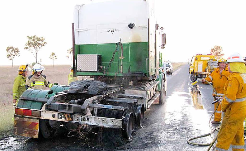 Rolleston rural firies dampen down and inspect the damage from a truck fire on the Dawson Hwy on Wednesday. Rolleston rural firies dampen down and inspect the damage from a truck fire on the Dawson Hwy on Wednesday.