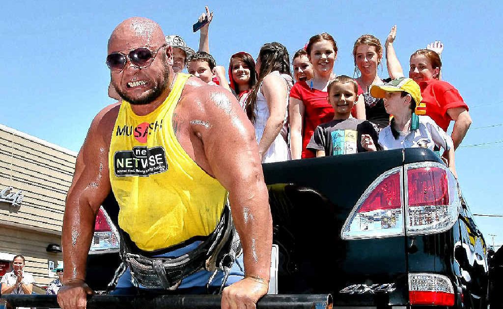 Derek Boyer lifting a ute to raise funds for McHappy Day on Saturday. Derek Boyer lifting a ute to raise funds for McHappy Day on Saturday.