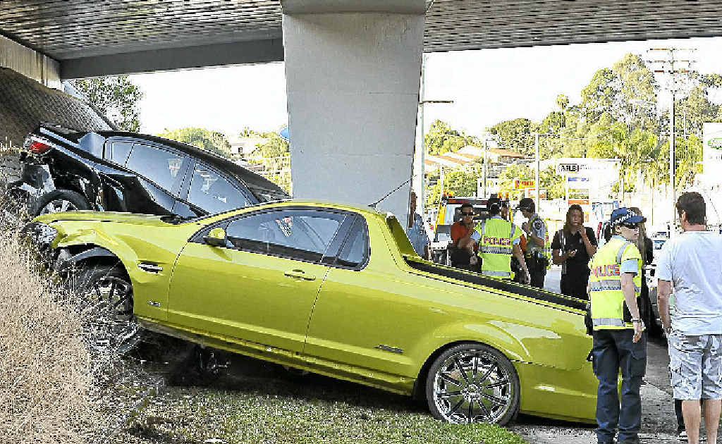 Police and onlookers look at the accused man’s utility and his former lover’s sedan, as the vehicles lie crumpled near Sugar Rd. Police and onlookers look at the accused man’s utility and his former lover’s sedan, as the vehicles lie crumpled near Sugar Rd.