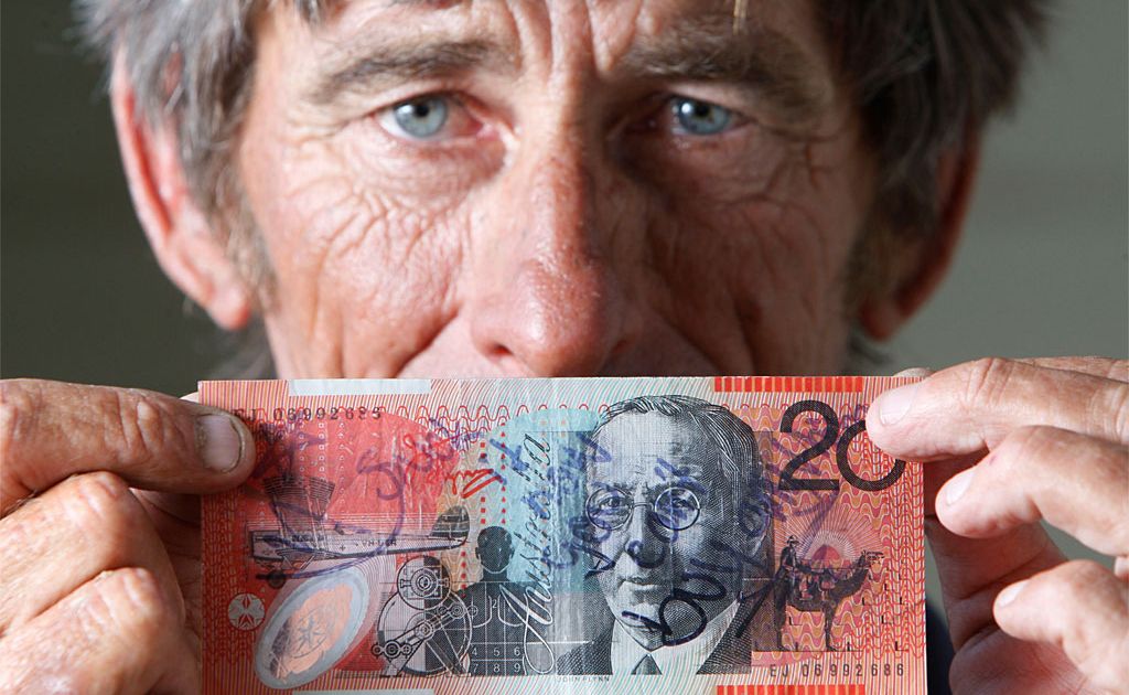 A frustrated Phillip Turner with the vandalised $20 note he received from a petrol station that no one will accept or swap. A frustrated Phillip Turner with the vandalised $20 note he received from a petrol station that no one will accept or swap.