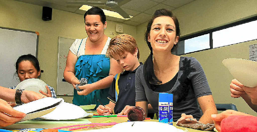 LIFE LESSONS: Student teachers Stephanie Bouzige and Elizabeth Smith, from Hawaii, with Robina Primary School students Monica Chen and James Martin. LIFE LESSONS: Student teachers Stephanie Bouzige and Elizabeth Smith, from Hawaii, with Robina Primary School students Monica Chen and James Martin.