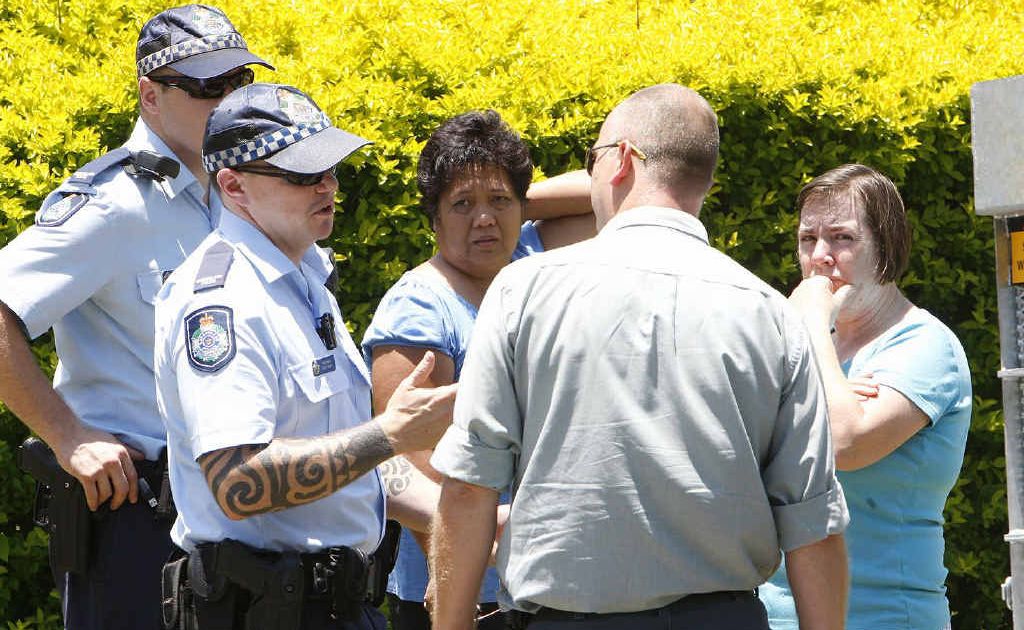Police and animal management officers speak to residents Marilou Mortensen and Robyn Watson at the scene where two dogs mauled a family cat to death. Police and animal management officers speak to residents Marilou Mortensen and Robyn Watson at the scene where two dogs mauled a family cat to death.