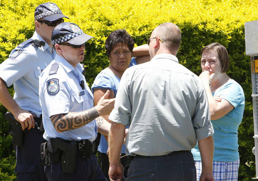 Police and animal management officers speak to residents Marilou Mortensen and Robyn Watson at the scene where two dogs mauled a family cat to death. Police and animal management officers speak to residents Marilou Mortensen and Robyn Watson at the scene where two dogs mauled a family cat to death.
