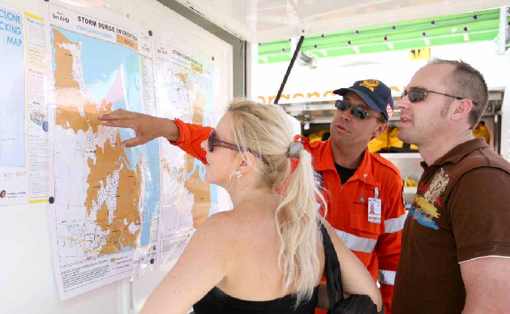 SES volunteer John Williamson explains cyclone preparation and flood zones to Mackay residents Emma Davis and Darren Pugh at Cyclone Saturday, held at McGinns at the weekend.