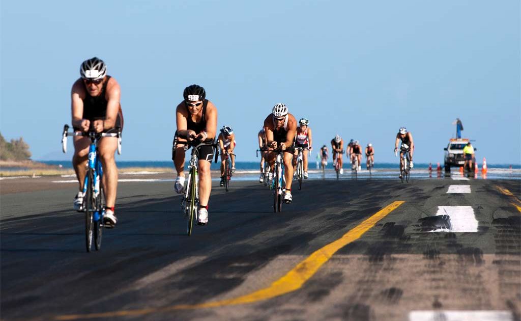 BIKING IT: Competitors race across the runway during the bike leg of the Hamilton Island triathlon. BIKING IT: Competitors race across the runway during the bike leg of the Hamilton Island triathlon.