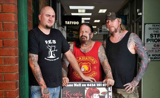 Owners of Kronic Tattoo Luke McLachlan, Bradley Cooper and Neil Overwater with the sign deemed offensive by Clarence Valley Council. Owners of Kronic Tattoo Luke McLachlan, Bradley Cooper and Neil Overwater with the sign deemed offensive by Clarence Valley Council.