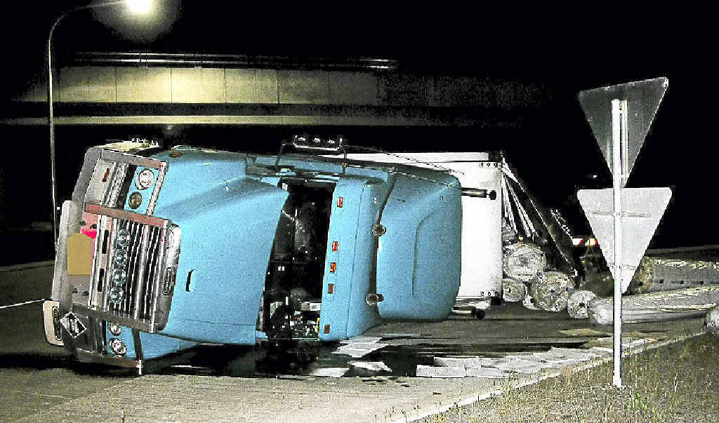 The driver of this truck, which rolled at the Teven interchange on Tuesday night, walked away with only an injured shoulder. It was the second such incident on the new piece of road in eight days. The driver of this truck, which rolled at the Teven interchange on Tuesday night, walked away with only an injured shoulder. It was the second such incident on the new piece of road in eight days.