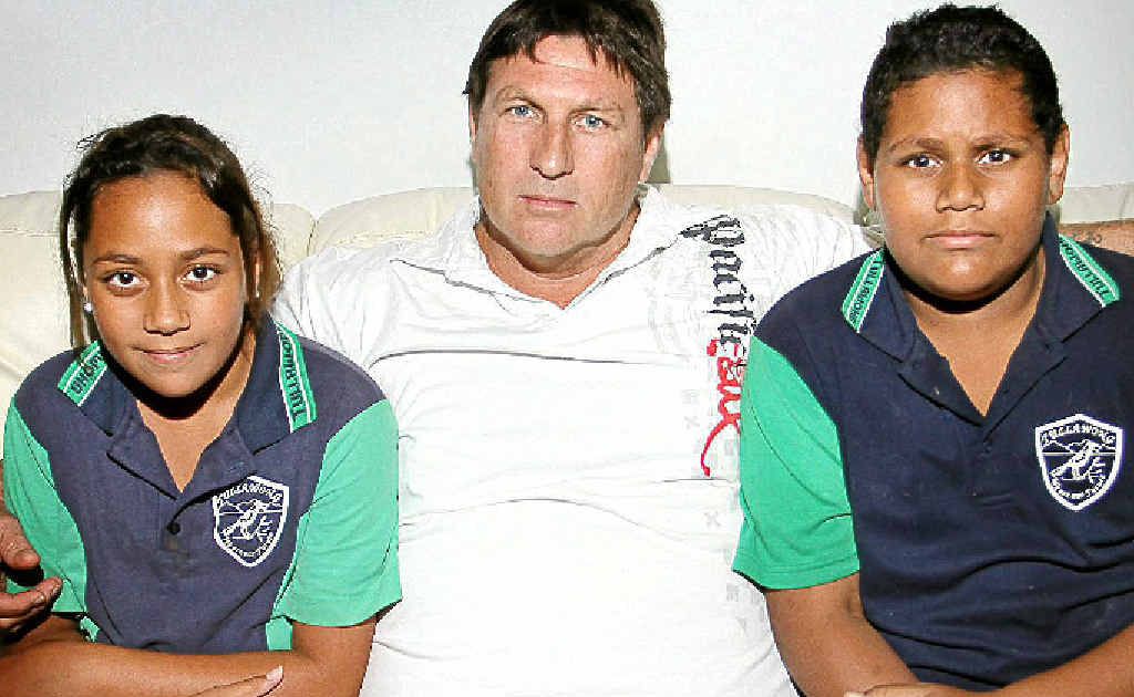 Mark White with his children Matthew (12) and Emily (11) is taking legal action against Queensland Health. Mark White with his children Matthew (12) and Emily (11) is taking legal action against Queensland Health.
