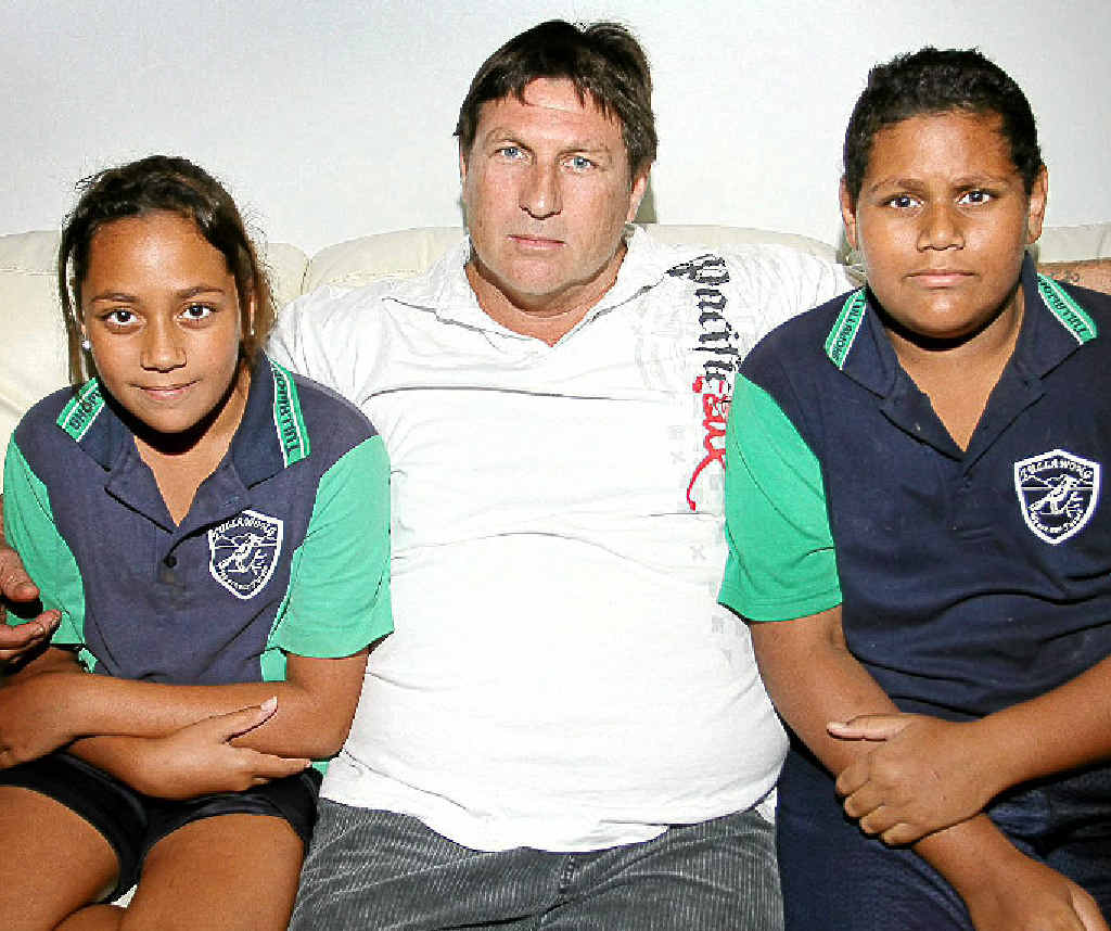 Mark White with his children Matthew (12) and Emily (11) is taking legal action against Queensland Health. Mark White with his children Matthew (12) and Emily (11) is taking legal action against Queensland Health.