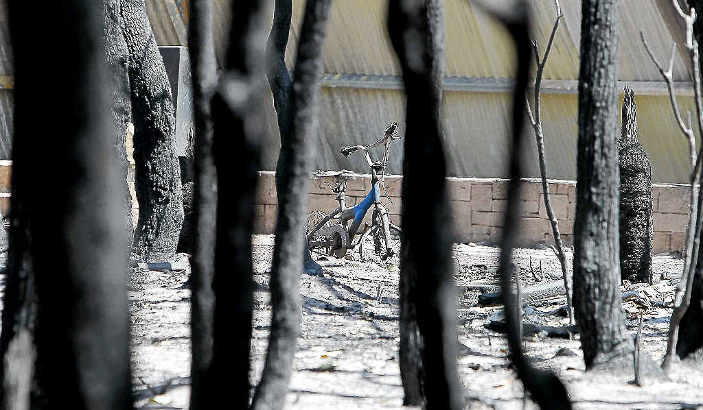 A child’s bicycle sits destroyed among blackened tree trunks outside a house on Orchard Ramble after a bushfire in Margaret River. A child’s bicycle sits destroyed among blackened tree trunks outside a house on Orchard Ramble after a bushfire in Margaret River.