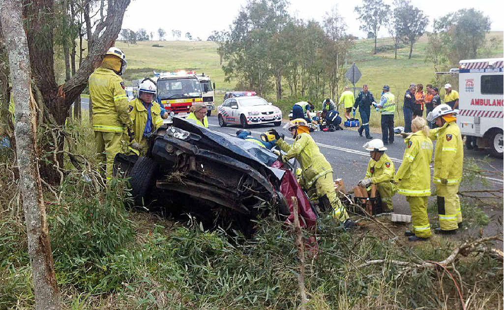 Emergency service personnel work at the scene of the accident, a kilometre east of Kilcoy, yesterday. Emergency service personnel work at the scene of the accident, a kilometre east of Kilcoy, yesterday.