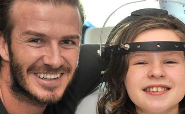 David Beckham poses for a picture with a girl at Royal Melbourne Children's Hospital. David Beckham poses for a picture with a girl at Royal Melbourne Children's Hospital.