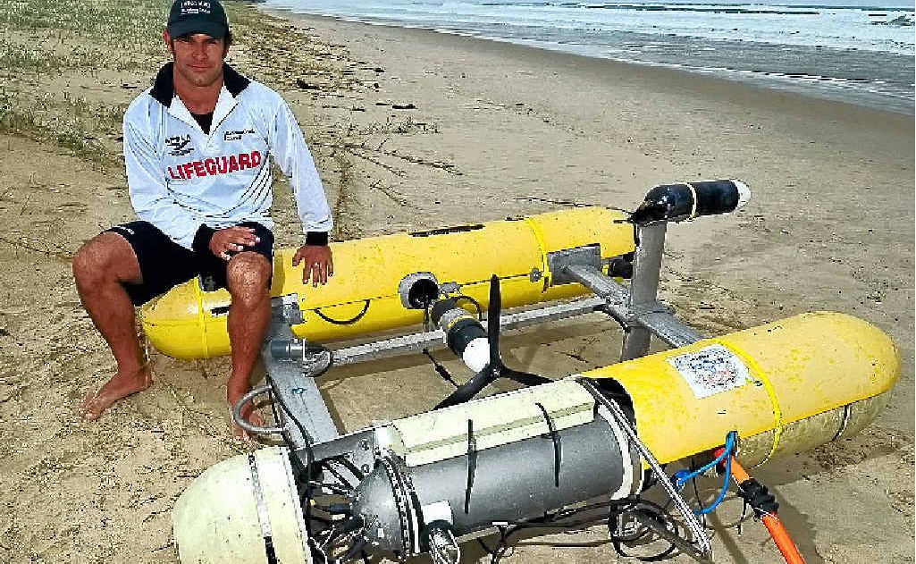 Lifeguard Peter Cherry with the sophisticated submersible vehicle washed up on Glen Eden Beach at North Peregian. Lifeguard Peter Cherry with the sophisticated submersible vehicle washed up on Glen Eden Beach at North Peregian.