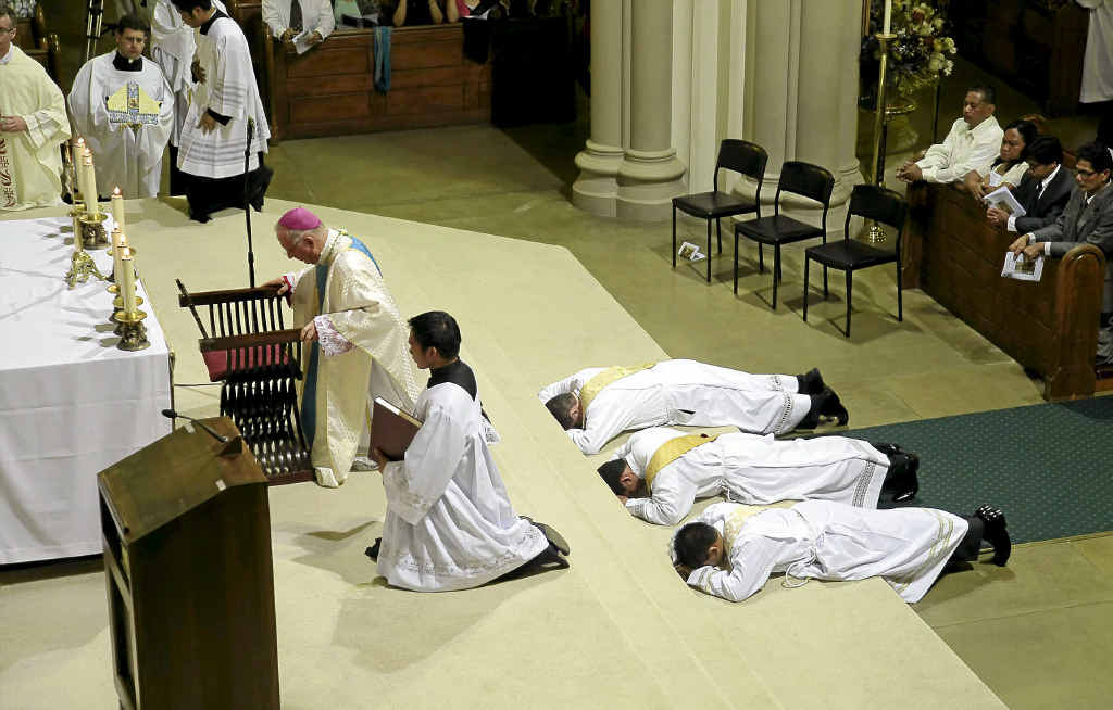 Bishop Geoffrey Jarrett of the Lismore Diocese conducts the ordination to the priesthood of (from left) James Foster, Roland Agrisola and Shelwin Fernandez at St Carthage’s Cathedral, Lismore. 