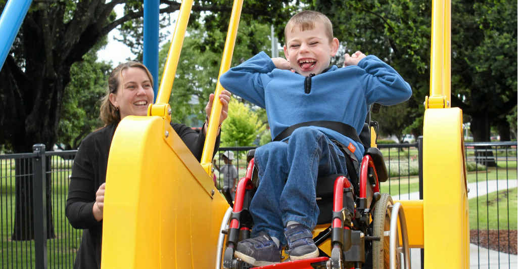 Cody Bergemann and mum Heidi can’t keep the grins off their faces at the opening of the new Leslie Park playground and liberty swing. Cody Bergemann and mum Heidi can’t keep the grins off their faces at the opening of the new Leslie Park playground and liberty swing.