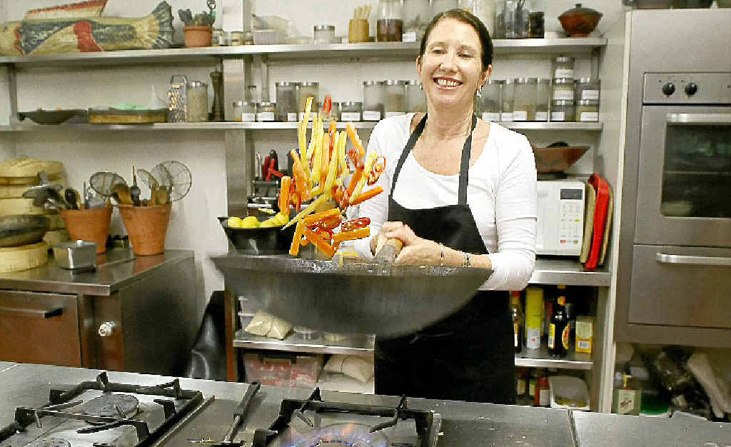 WHAT’S COOKING? Chef Annette Fear whips up a dish in the kitchen of The Spirit House Cooking School. WHAT’S COOKING? Chef Annette Fear whips up a dish in the kitchen of The Spirit House Cooking School.