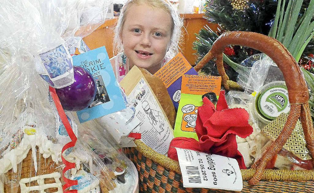 Sari Conti, whose great grandparents were Hunchy (near Palmwoods) pineapple farmers, enjoys the family fun of making a gift hamper at the Big Pineapple Growers and Fine Food Markets. Sari Conti, whose great grandparents were Hunchy (near Palmwoods) pineapple farmers, enjoys the family fun of making a gift hamper at the Big Pineapple Growers and Fine Food Markets.