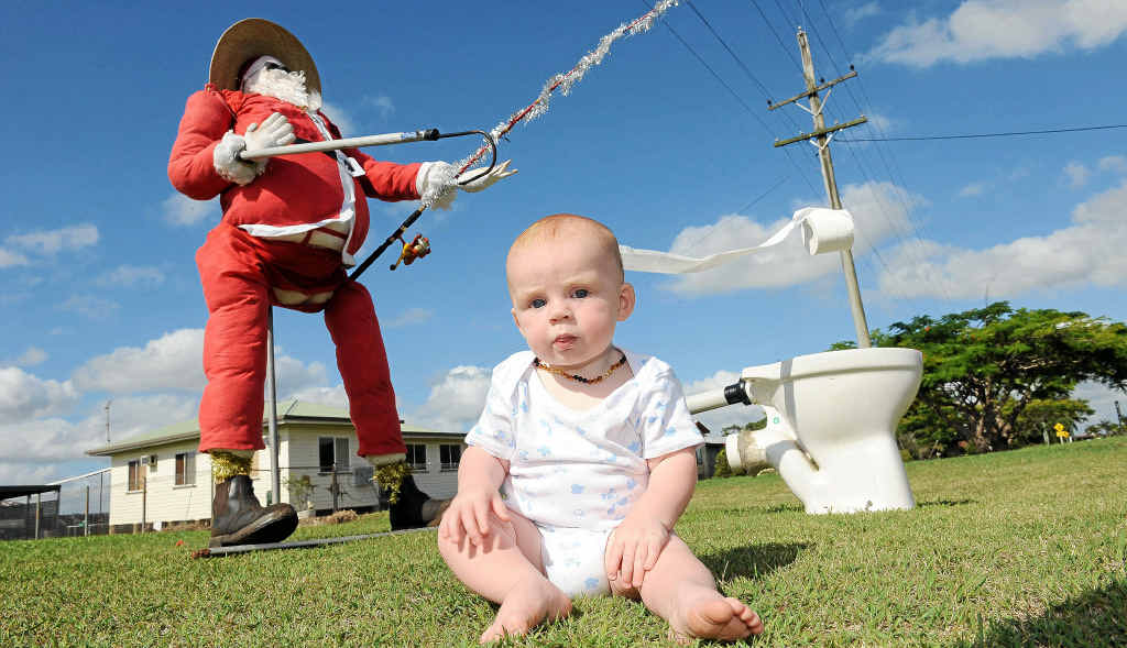 Xavier Kelly with his nana’s roadside Santa, who is placed in different poses every day to entertain passing motorists. Xavier Kelly with his nana’s roadside Santa, who is placed in different poses every day to entertain passing motorists.
