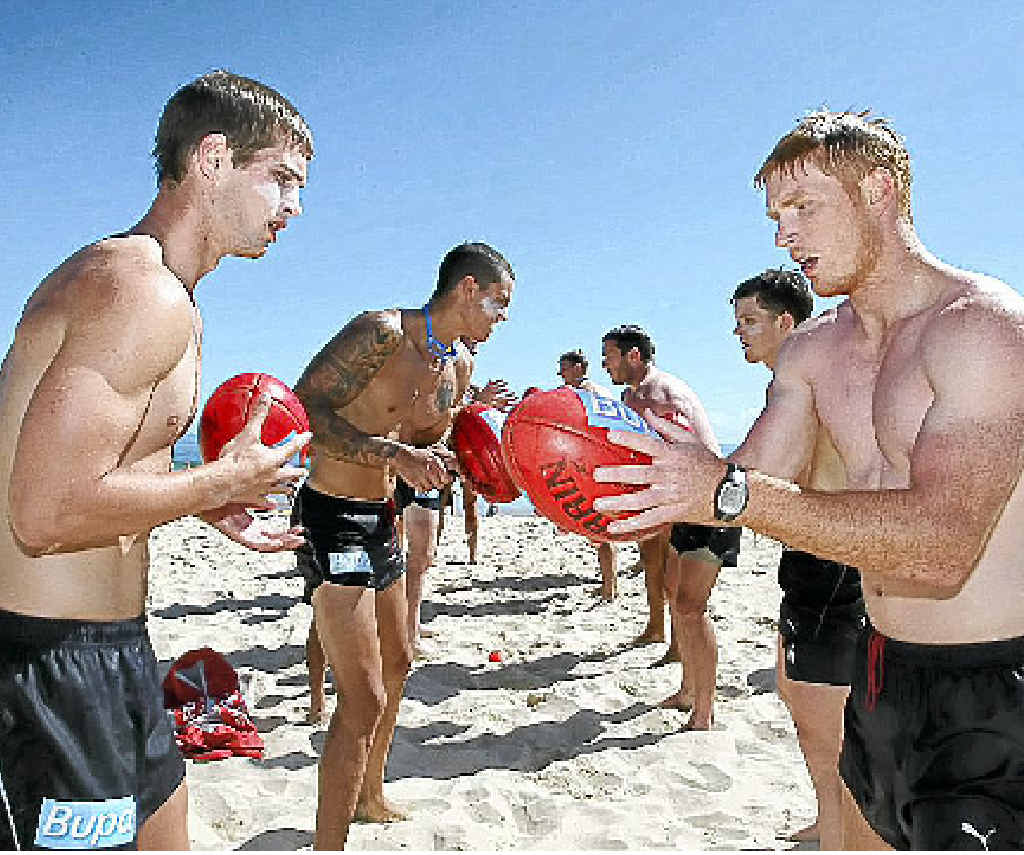 Hawthorn footballers practise handballs during a training session at Mooloolaba. Hawthorn footballers practise handballs during a training session at Mooloolaba.