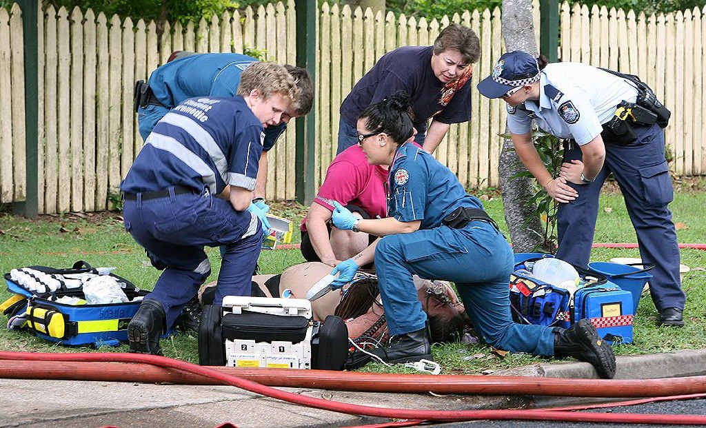 Paramedics attend to a woman who suffered burns in a house fire on Christmas Eve. Paramedics attend to a woman who suffered burns in a house fire on Christmas Eve.