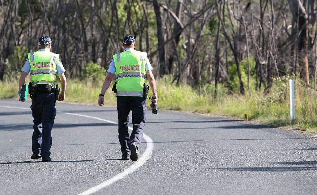 Forensic Crash investigator Matthew Cummins and Sgt Bill Feldman walk to the point where the motorbike left the road to investigate the crash. Forensic Crash investigator Matthew Cummins and Sgt Bill Feldman walk to the point where the motorbike left the road to investigate the crash.