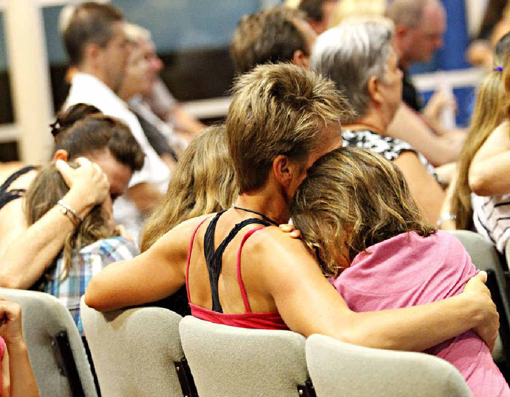 Mums comfort their children as friends and family of the Golinskis gather at The Anglican Church of Noosa yesterday. Mums comfort their children as friends and family of the Golinskis gather at The Anglican Church of Noosa yesterday.