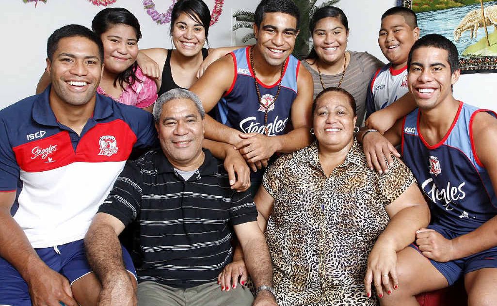 Former Goodna Eagle’s player Lama Tasi (far left) with his family at their Goodna home. Former Goodna Eagle’s player Lama Tasi (far left) with his family at their Goodna home.