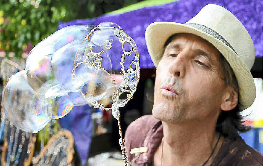 FESTIVAL FROTH AND BUBBLE: JK Hopper blows bubbles for the crowds at the Woodford Folk Festival. FESTIVAL FROTH AND BUBBLE: JK Hopper blows bubbles for the crowds at the Woodford Folk Festival.